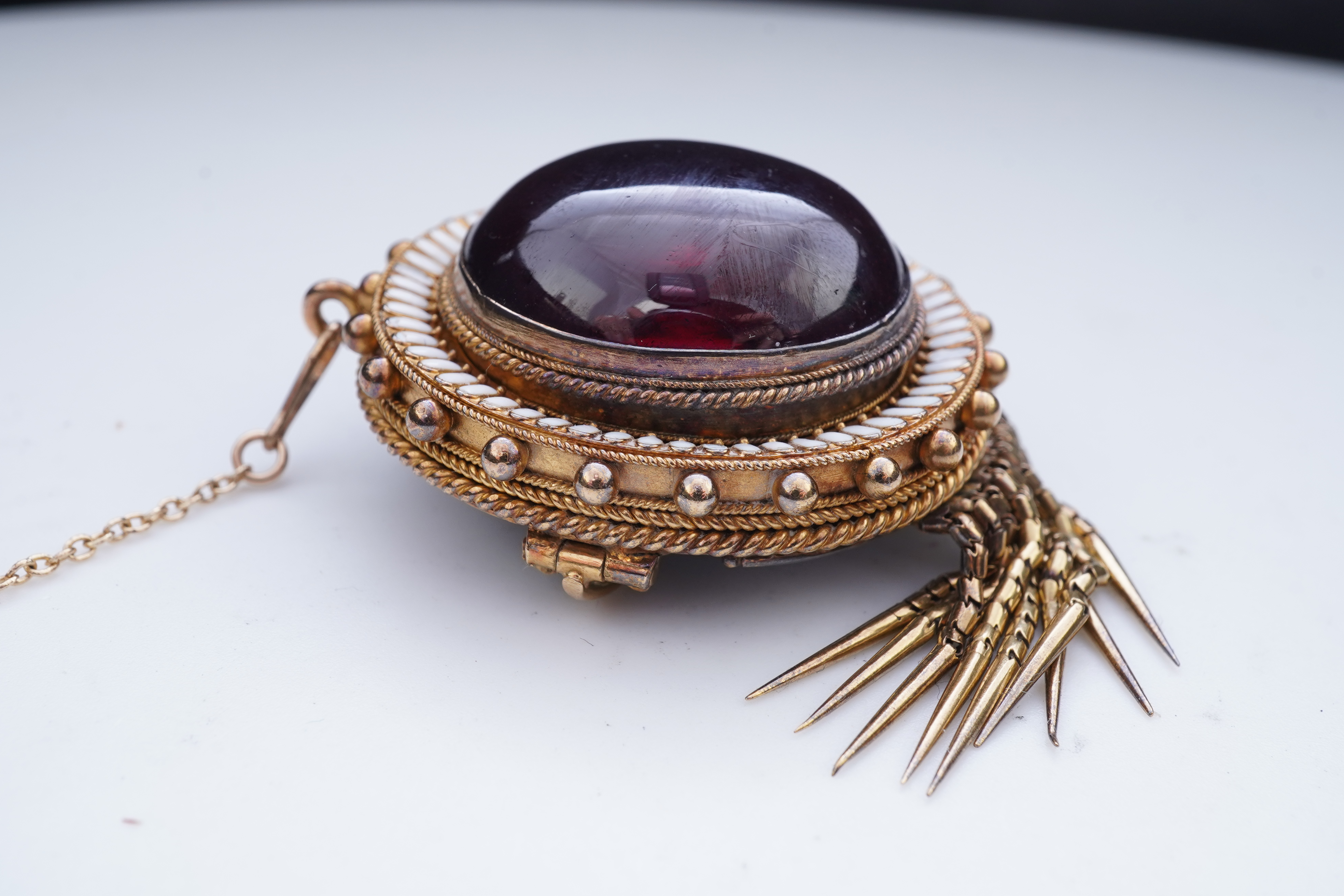 A Victorian garnet and enamel brooch, mid 19th century